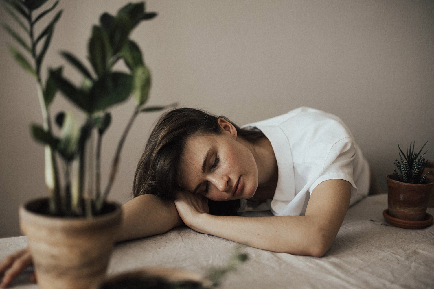 lady sleeping with head on arm 